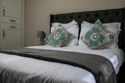 a large bed with two pillows on top of it at Home Very Close To CBD in Gaborone