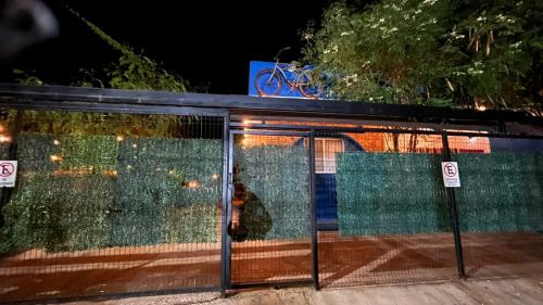 a glass facade of a building with a bike on top at Casa Luna Bonita in Cabo San Lucas