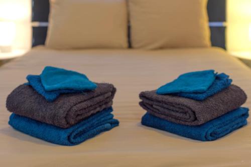two towels sitting on top of a bed at Kait location in Pont-sur-Yonne