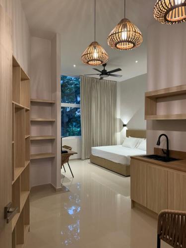 a bedroom with a bed and a desk and lights at Almera Vallarta Hotel Suites in Nuevo Vallarta