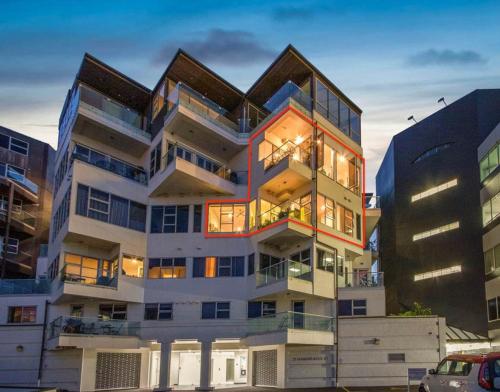 a tall white building with a lot of windows at 3 Bedroom Split Level 125sqm Sub Penthouse in St Marys Bay in Auckland