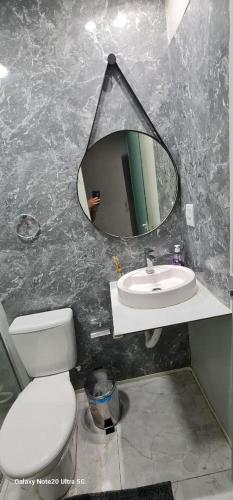 a bathroom with a mirror and a toilet and a sink at THEHotelBoutiqueCidadeVelha in Belém