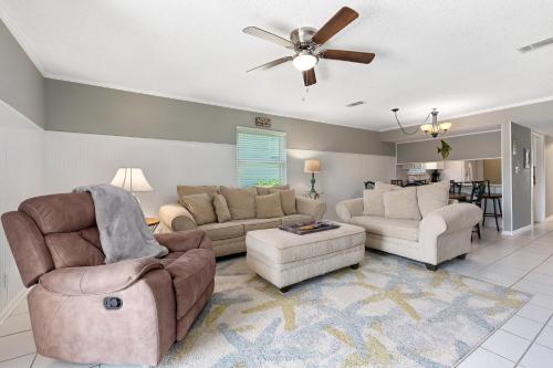 a living room with couches and a ceiling fan at Allendale Docks in Destin