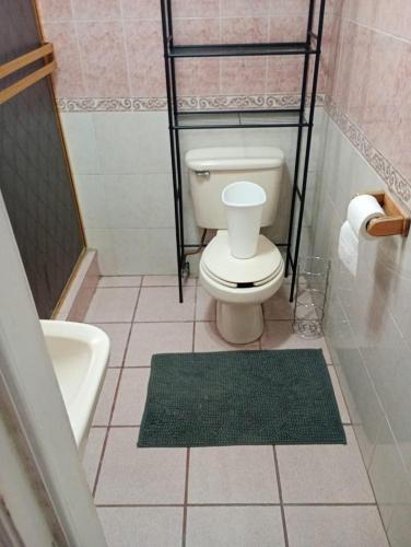a bathroom with a toilet and a bath tub at Casa visas656 in Manuel F. Martínez