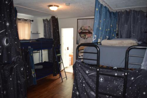 a room with two bunk beds in a room with stars at Drip Star Life Hostel Miami 3 in Parkway Regional Medical Center Heliport