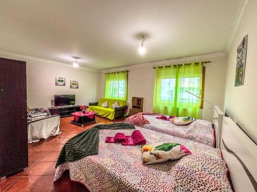 a bedroom with two beds and a living room at Family holiday home new beds in Bragança