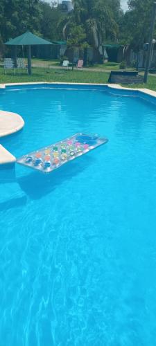 a floating island in the middle of a swimming pool at Cabañas LAS PALMERAS in La Paz