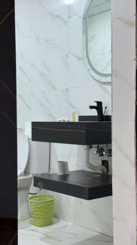 a bathroom with a sink and a toilet and a mirror at Wadi Rum party luxury camp in Disah