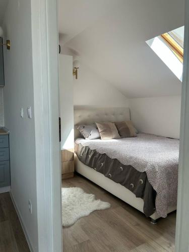 a bedroom with a bed in a attic at SarajevoView in Ivišovo Greblje