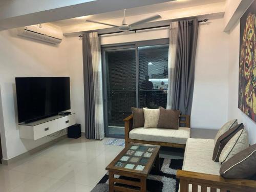 a living room with a couch and a tv at Oval View Residencies By C in Colombo