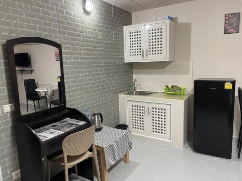 a kitchen with a black refrigerator and a table at Dailyroom C3,C4by Anna in Nonthaburi