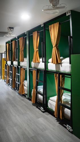 a row of bunk beds in a room at The Highdogs Hostel in Phi Phi Islands