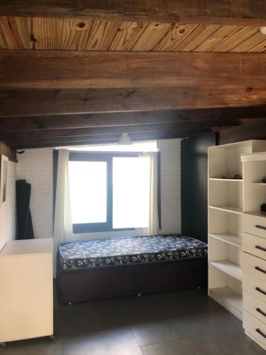 a bed in a room with a window at Casa rústica in Torres