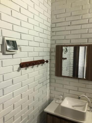 a white bathroom with a sink and a mirror at Casa rústica in Torres