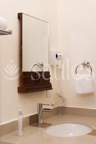a bathroom with a sink and a mirror at Saules Sueño in Cancún