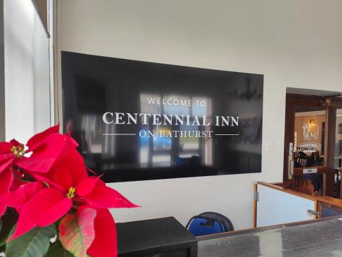 a wall with a sign that says welcome to centennial inn on ninth street at Centennial Inn on Bathurst in Launceston