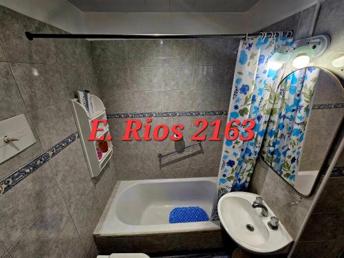 a bathroom with a tub and a toilet and a sink at Dos ambientes plaza colon in Mar del Plata