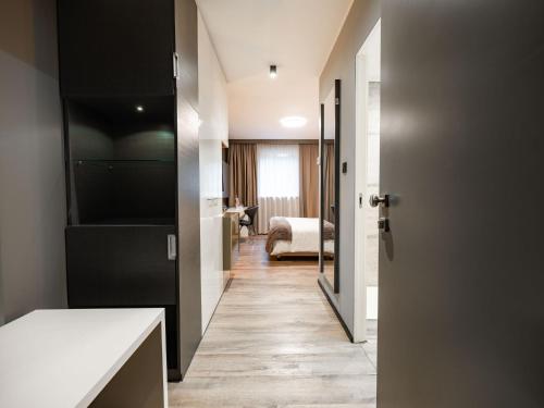a room with a door leading to a bedroom at Hotel City Maribor in Maribor
