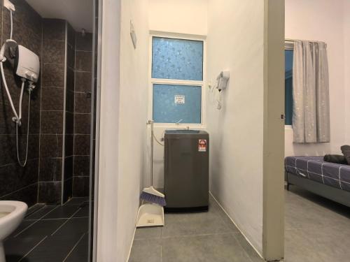 a bathroom with a sink and a toilet and a window at Langkawi Simfoni Lavanya Suite 13 in Kuah
