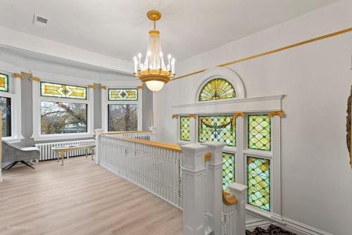 a home with a staircase and stained glass windows at The Palace in Rockford