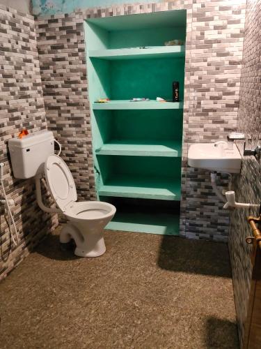 a bathroom with a toilet and a sink at Lakecampers for foreign travellers in Alleppey