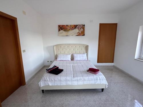 a bedroom with a bed with two pillows on it at Fantastic sea & harbour view Nino Bixio in Castellammare del Golfo