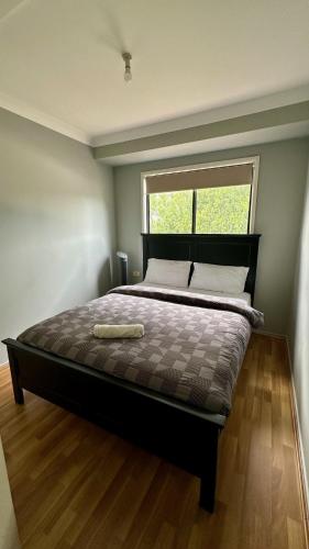 a large bed in a room with a window at Home away from home! in Liverpool