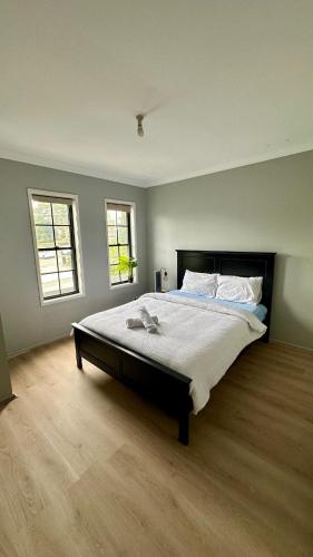 a bedroom with a large bed and two windows at Home away from home! in Liverpool