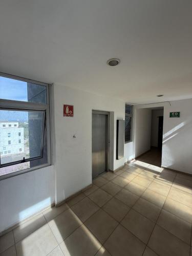 an empty room with a large window in a building at Departamento Torres del Rio Privada Desarrollo Urbano Tres Rios Facturamos in Culiacán