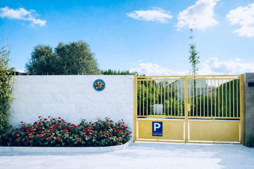 een hek met een poort, versierd met bloemen, en een parkeermeter bij Luxury Villa with Pool & Garden5km from Cabo in Tetouan