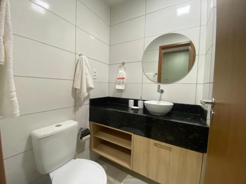 a bathroom with a toilet and a sink and a mirror at Studio Praia de Carneiros in Praia dos Carneiros