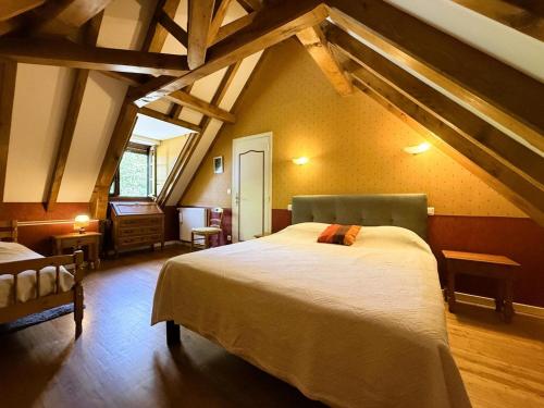a bedroom with a large bed in a attic at Moulin gratia in Lay-Lamidou
