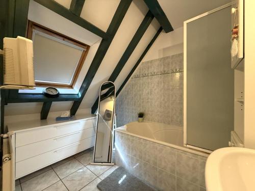 a bathroom with a bath tub and a sink at Moulin gratia in Lay-Lamidou