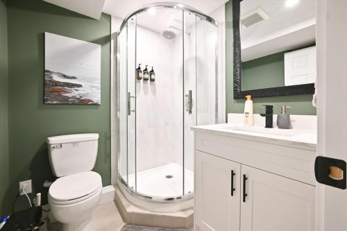 a bathroom with a shower with a toilet and a sink at Vancouver UBC 2BD Suite in Vancouver