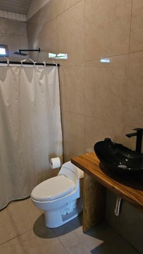 a bathroom with a toilet and a sink at KAIA VILLAGE, Santa Teresa, Costa Rica in Santa Teresa Beach