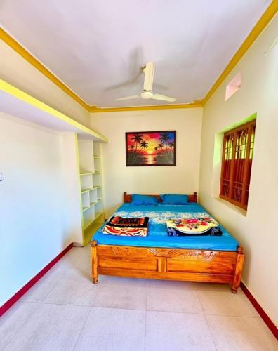 a bedroom with a bed in a room at Koraput Crown Homestay in Similigurha