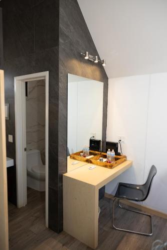 a bathroom with a vanity with a mirror and a sink at OENO WINE LODGE Valle de Guadalupe in Valle de Guadalupe