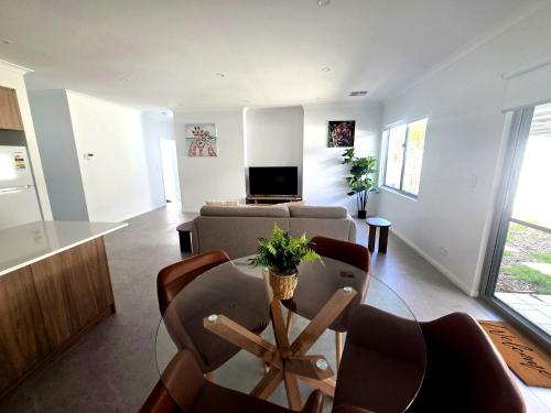 a living room with a table and a couch at Modern Private Townhouse Close to City & Transport in Perth