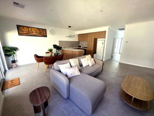 a living room with a couch and a table at Modern Private Townhouse Close to City & Transport in Perth
