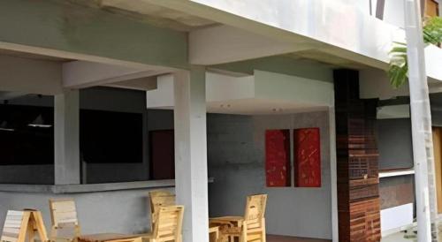 a group of chairs sitting outside of a house at K-1 Modern Art Hotel @ Nan in Nan