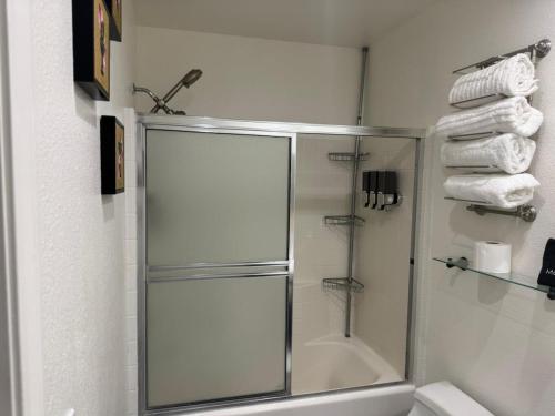 a bathroom with a shower with a glass door at Casa Pueblo in Desert Hot Springs