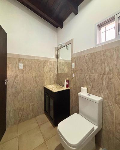 a bathroom with a toilet and a sink at Cabañas Pukara in Cafayate