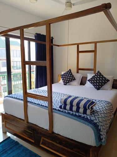 a bedroom with two bunk beds with blue and white pillows at Namaste sea view apartment in Canacona