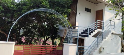 a building with a spiral staircase in front of a building at punartham homestay in Kovalam
