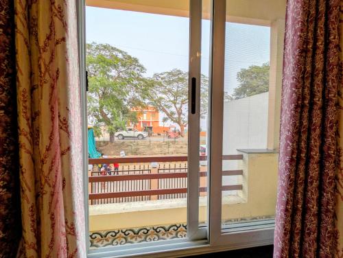 an open window with a view of a yard at Ganga Yamuna View in Prayagraj