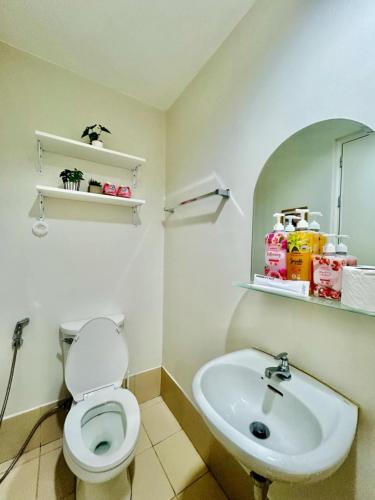 a bathroom with a toilet and a sink at 12F Condo at The Loop Tower Limketkai Center CDO in Cagayan de Oro