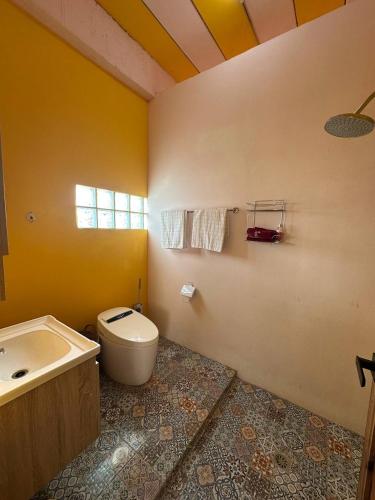 a bathroom with a toilet and a sink at Fluffy Cat Paradise in Ko Bu Bu