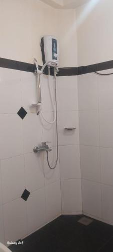 a bathroom with a shower with a phone on the wall at Mystik Muthu View Haputale in Haputale