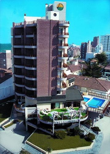 a large building with a pool and a resort at Hotel Gran International in Villa Gesell