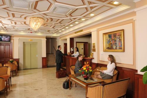 a group of people sitting in a lobby at Hotel Ködmön in Eger